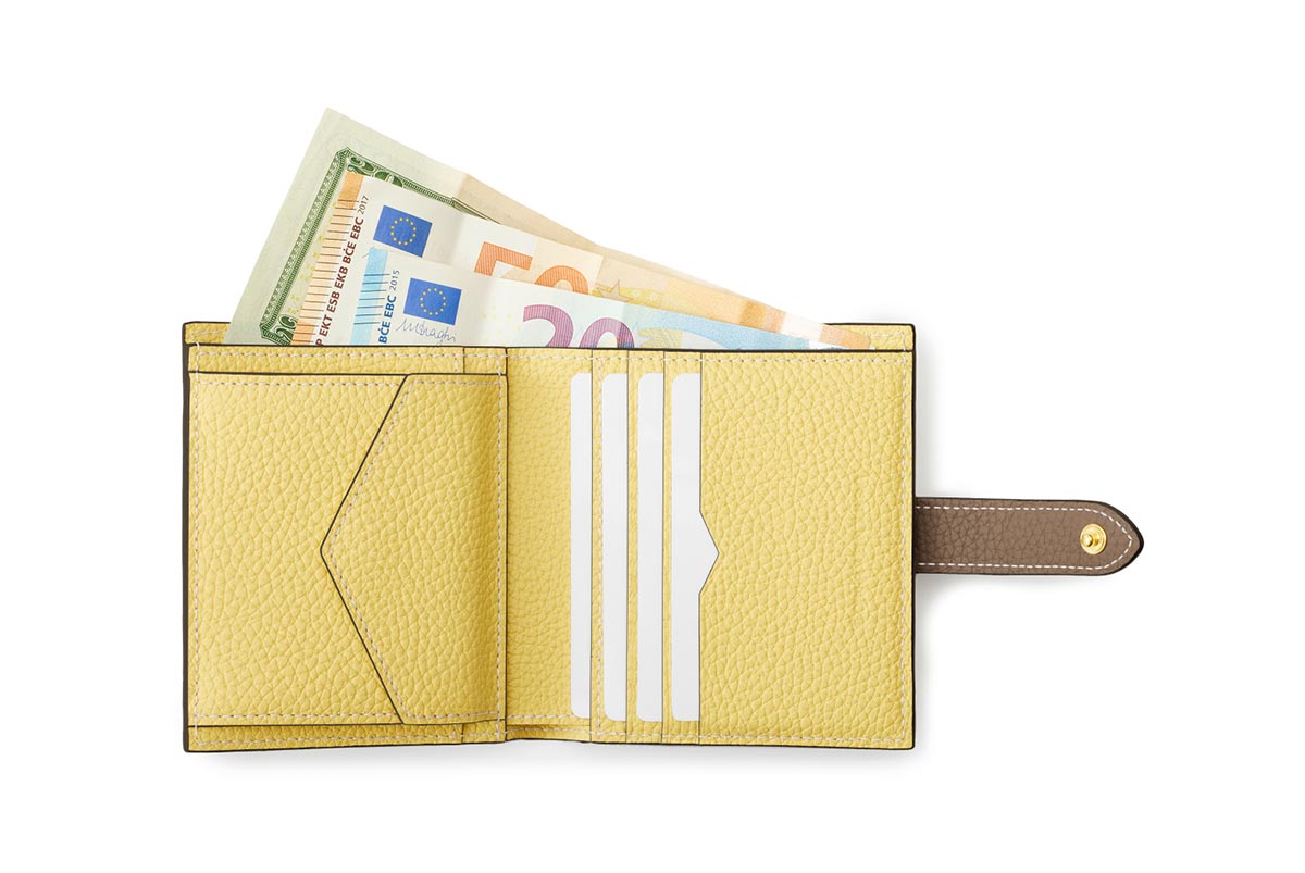 黄色のミニ財布の中にカードやお札が入っている様子