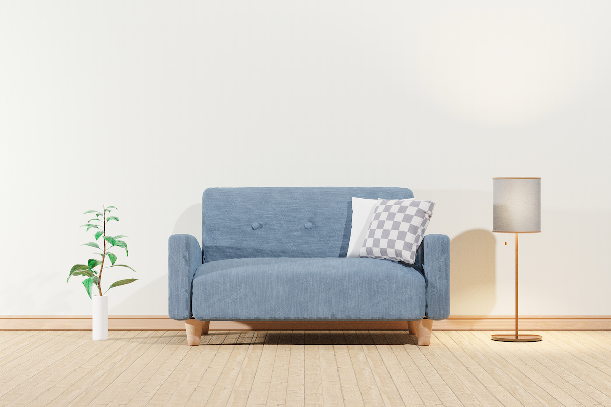 白い壁とフローリングの部屋の3Dイラスト　観葉植物、青色のソファー、フロアライトが置かれている