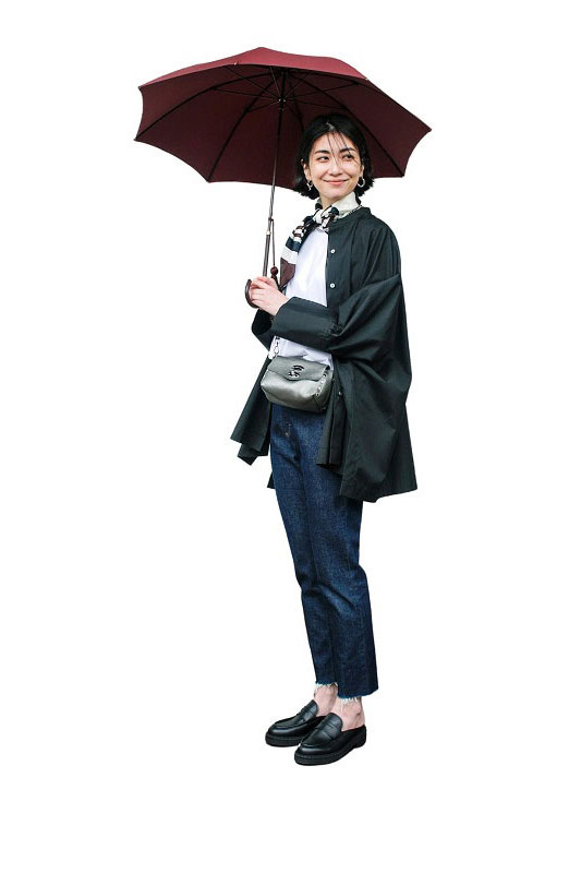 黒シャツ×白カットソー×デニムパンツの傘を差した女性