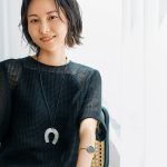 黒のワンピースで椅子に座る鈴木まきさん