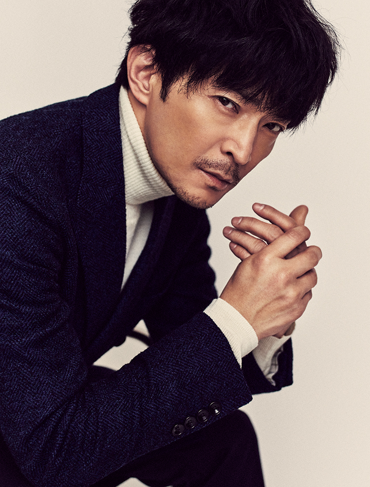 津田健次郎さん 座ってこちらを見る様子