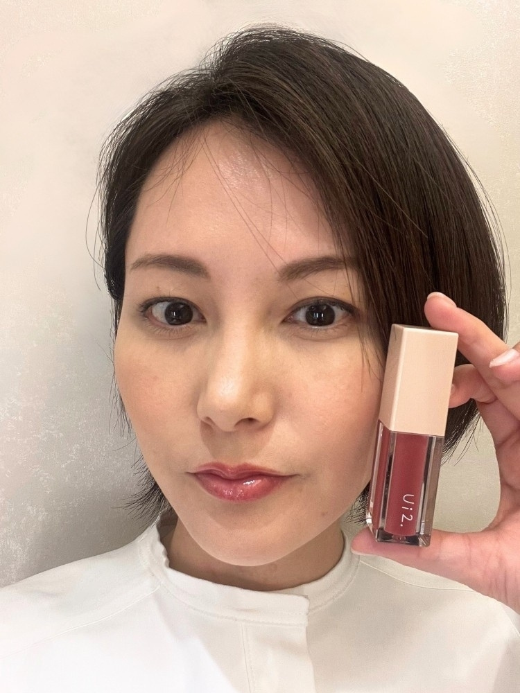 リップをつけた鈴木さんの写真。リップを手に持って撮影した写真