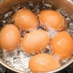 沸騰した鍋でゆで卵を作っている写真