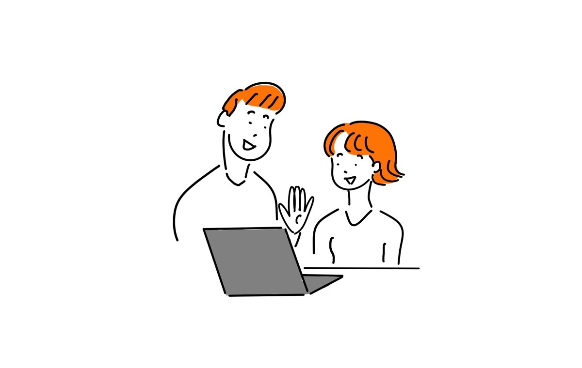 パソコンをみる男女