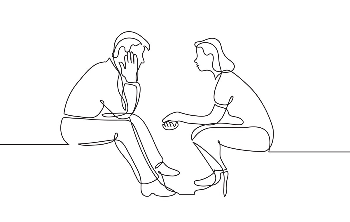 向かい合って座る男女